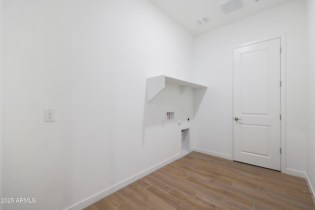 laundry area with light wood-type flooring, washer hookup, hookup for an electric dryer, and gas dryer hookup