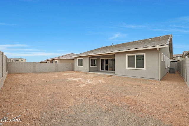 rear view of property with a patio area and central AC