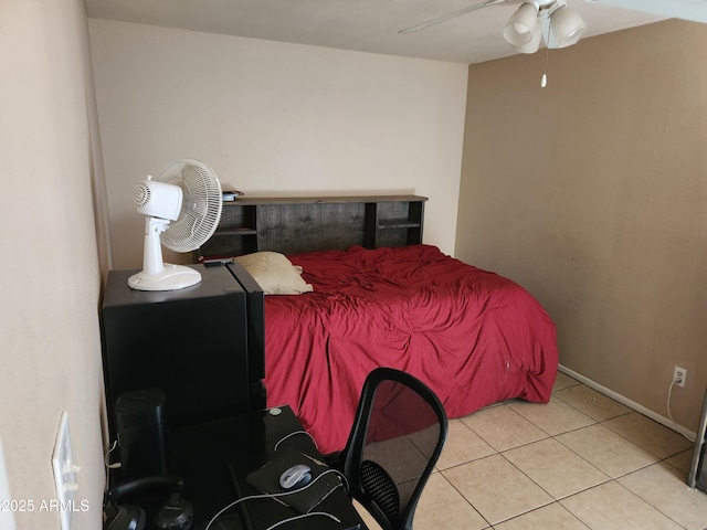 bedroom with a ceiling fan and tile patterned flooring