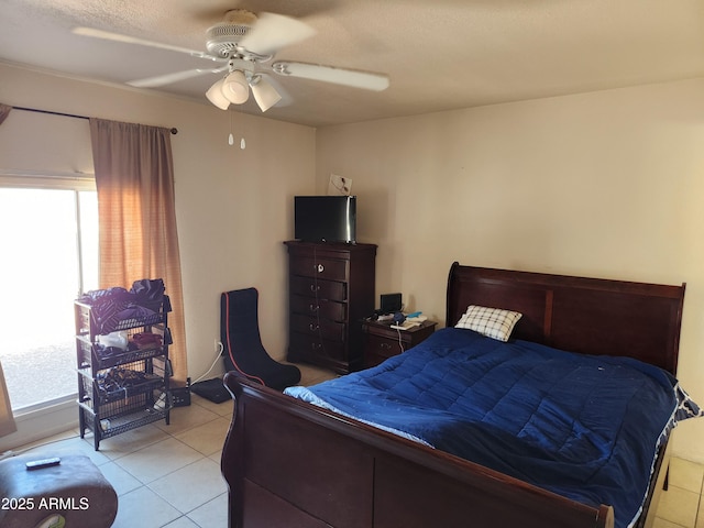 bedroom featuring light tile patterned floors, ceiling fan, and multiple windows