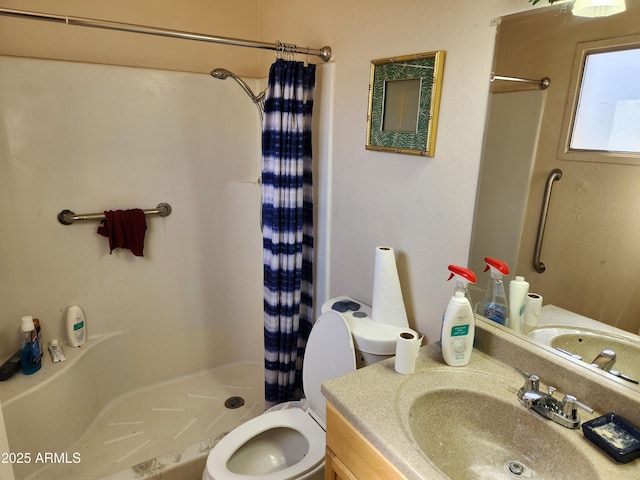 bathroom with curtained shower, vanity, and toilet