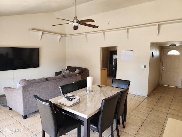 dining room with lofted ceiling, light tile patterned floors, and a ceiling fan