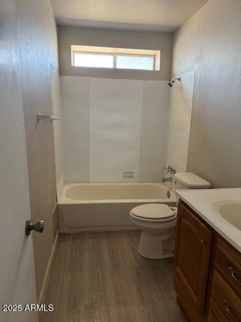 3840 N 43rd Ave Unit 16, Phoenix, AZ 85031 - bathroom featuring toilet, vanity, a wealth of natural light, and wood finished floors
