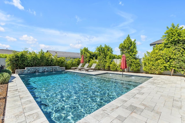 view of pool with pool water feature and a patio