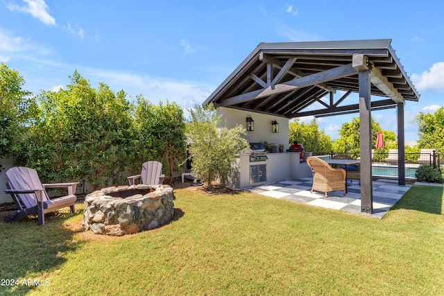 view of yard featuring a gazebo, a patio, exterior kitchen, and an outdoor fire pit