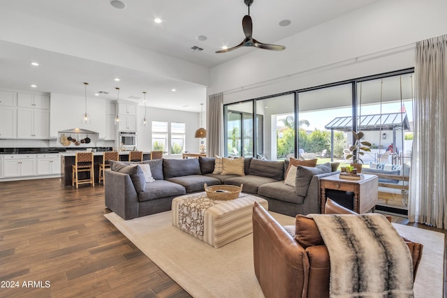 living room with wood-type flooring and ceiling fan