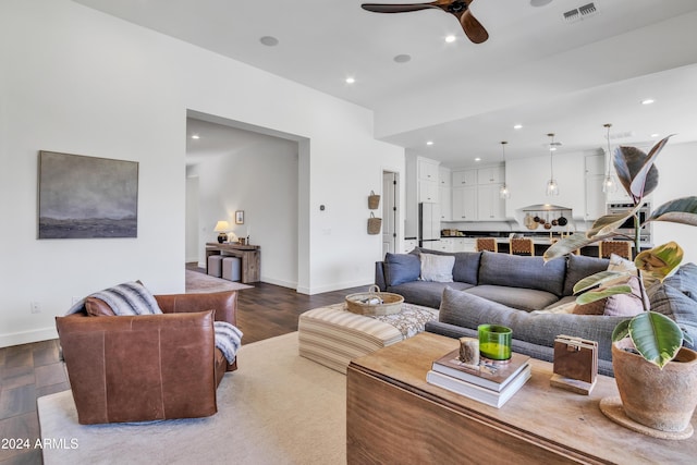 living room featuring ceiling fan and hardwood / wood-style floors