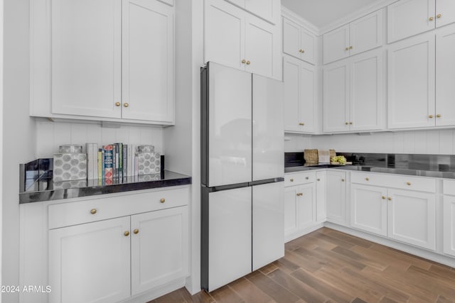 kitchen with white cabinets, stainless steel counters, white fridge, and dark hardwood / wood-style flooring