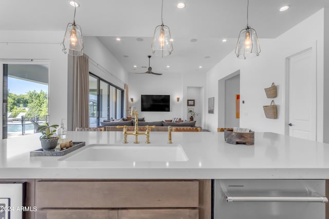 kitchen featuring sink, pendant lighting, and stainless steel dishwasher