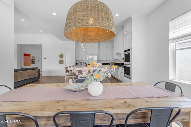 kitchen featuring white cabinetry, stainless steel double oven, and fridge