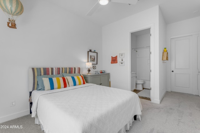 bedroom featuring ceiling fan, light carpet, connected bathroom, and a closet