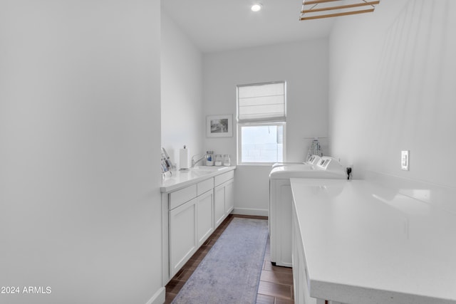 washroom with separate washer and dryer and sink