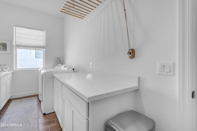 washroom with washer and clothes dryer and cabinets