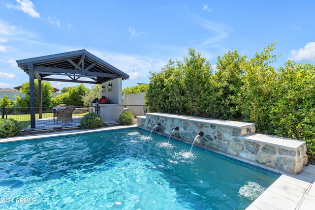 view of swimming pool with pool water feature