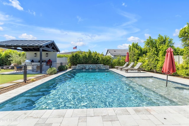 view of swimming pool featuring pool water feature and a patio