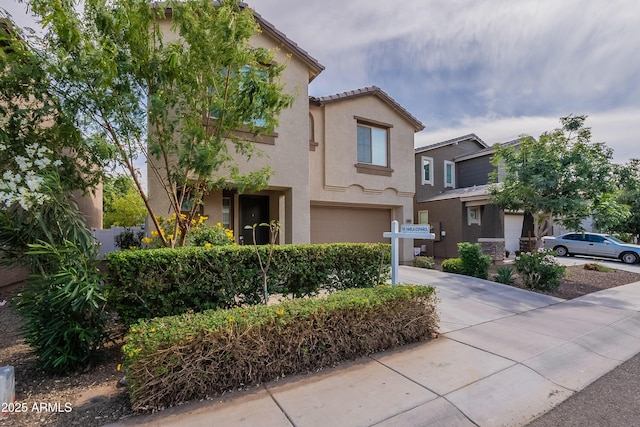 8905 W Jefferson St, Tolleson, AZ 85353 - mediterranean / spanish-style house with concrete driveway, stucco siding, and a garage