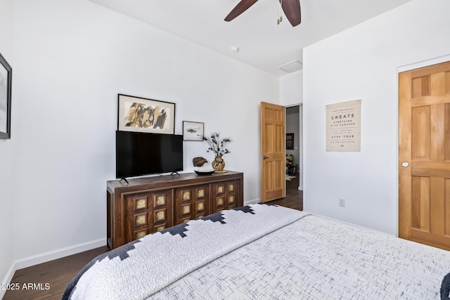 bedroom with dark hardwood / wood-style flooring and ceiling fan