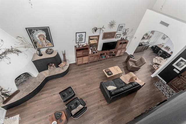 living room featuring a high ceiling and hardwood / wood-style floors