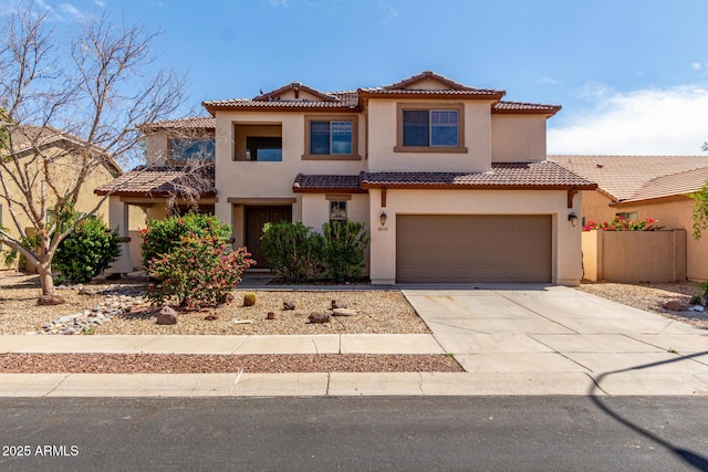 view of front of house featuring concrete driveway, a garage, a tile roof, and stucco siding