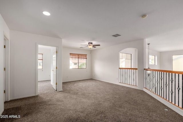 empty room with ceiling fan, visible vents, baseboards, carpet flooring, and recessed lighting