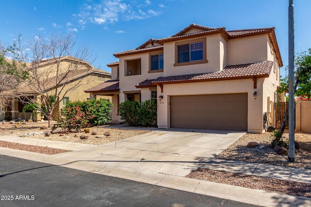mediterranean / spanish home featuring a tiled roof, driveway, a garage, fence, and stucco siding