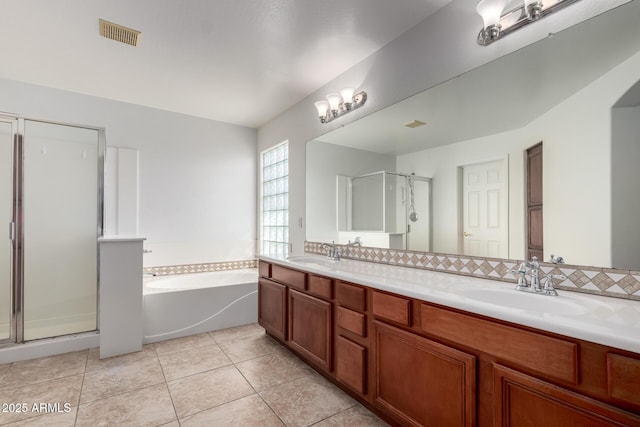 bathroom with visible vents, a sink, a bath, and a stall shower
