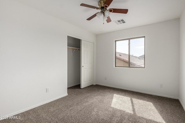 unfurnished bedroom featuring a closet, baseboards, carpet flooring, and visible vents