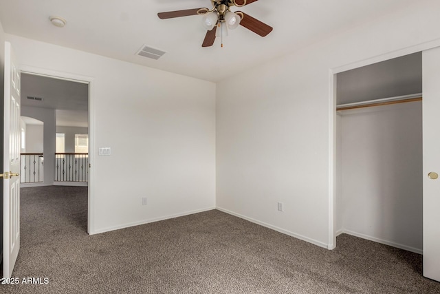 unfurnished bedroom featuring visible vents, carpet flooring, baseboards, and a closet