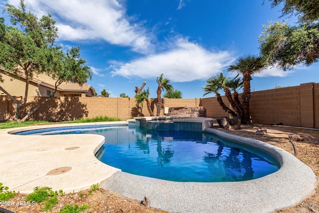 view of pool with a fenced backyard and a pool with connected hot tub