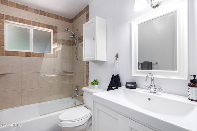 full bathroom with tiled shower / bath, toilet, and vanity