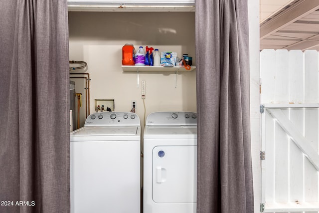 clothes washing area with washing machine and dryer