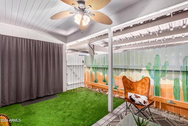 interior space with ceiling fan