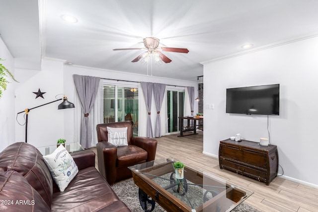 living room with ceiling fan, ornamental molding, and light wood-type flooring