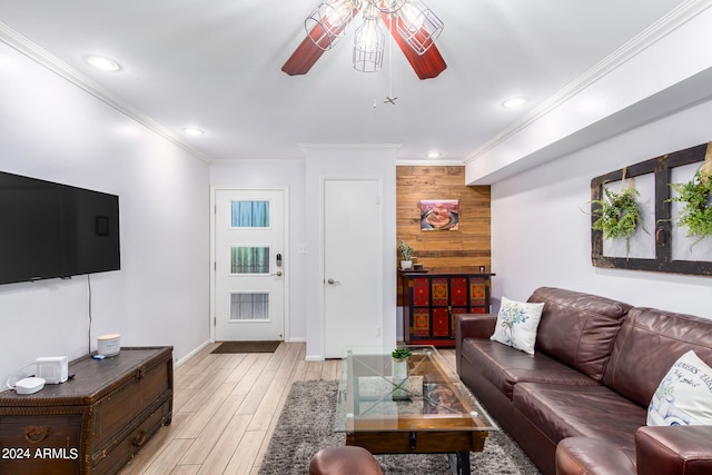 living room featuring crown molding, light hardwood / wood-style flooring, wood walls, and ceiling fan