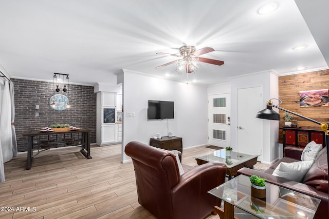 living room featuring light hardwood / wood-style flooring, ceiling fan, and ornamental molding