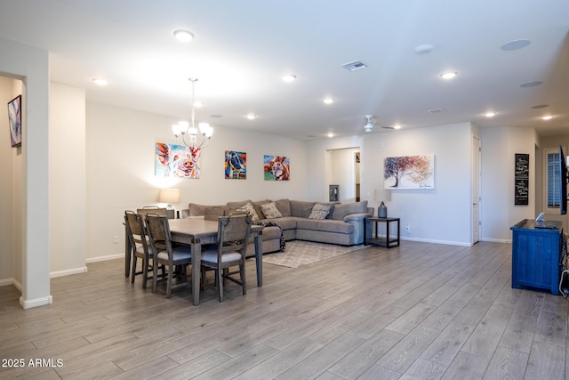 dining room featuring light hardwood / wood-style floors and a chandelier