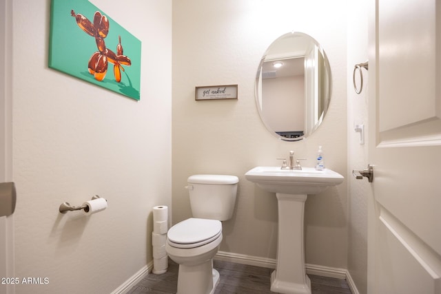 bathroom with sink, hardwood / wood-style floors, and toilet