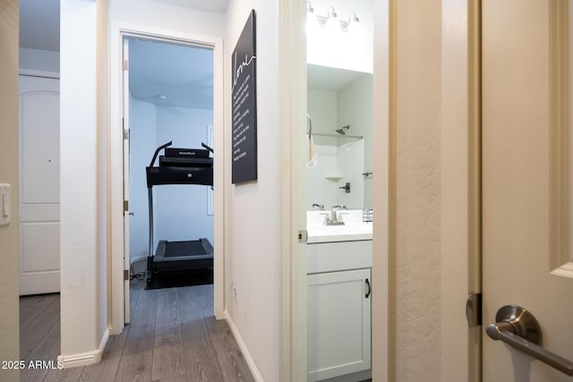 corridor with sink and dark hardwood / wood-style floors