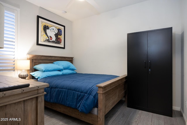 bedroom featuring ceiling fan and dark hardwood / wood-style flooring