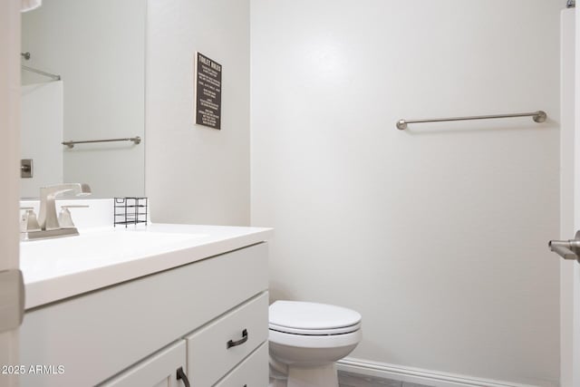 bathroom featuring toilet and vanity