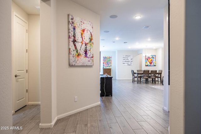 corridor with light hardwood / wood-style flooring