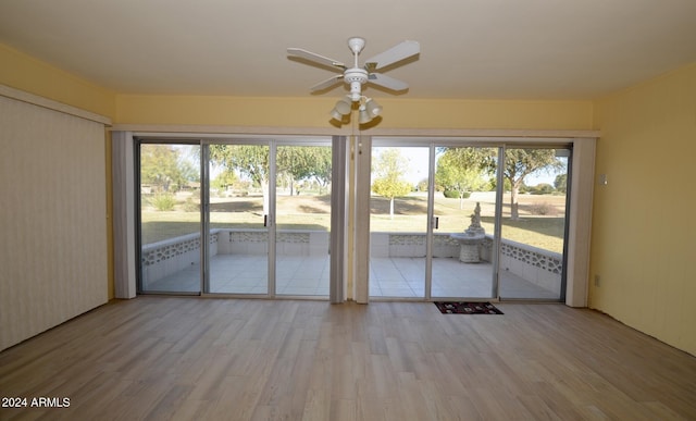 unfurnished sunroom featuring ceiling fan