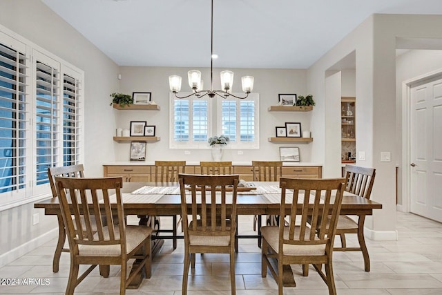 tiled dining space with a notable chandelier