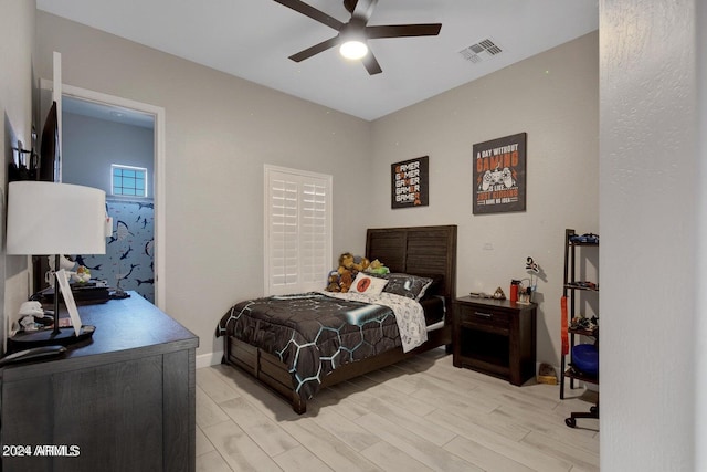 bedroom with light hardwood / wood-style floors and ceiling fan