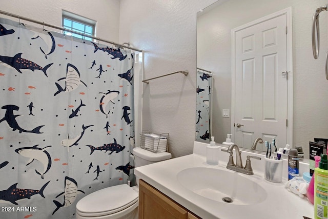 full bath with curtained shower, toilet, vanity, and a textured wall
