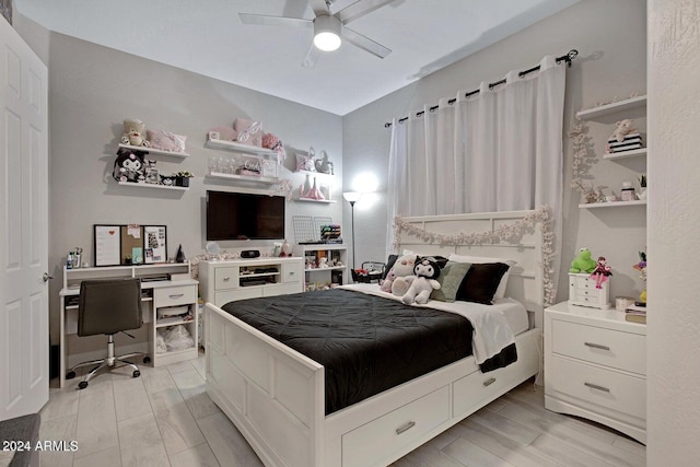 bedroom featuring ceiling fan and wood finish floors