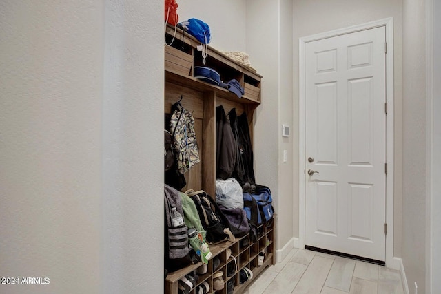 mudroom featuring wood finish floors and baseboards