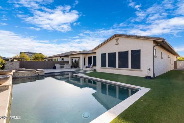 view of pool featuring a patio and a yard