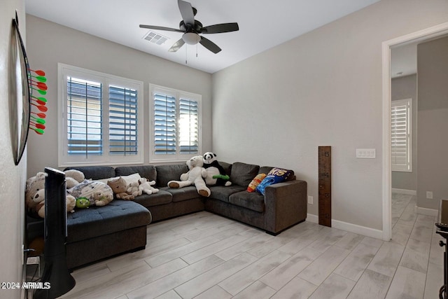 living room with ceiling fan and light hardwood / wood-style floors