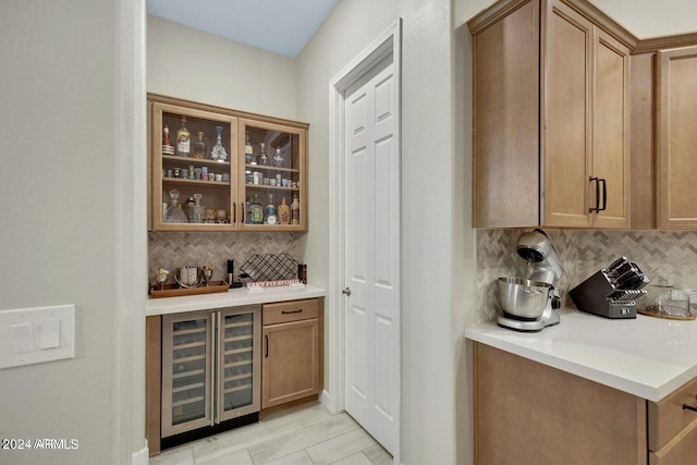 bar featuring decorative backsplash, beverage cooler, and indoor bar